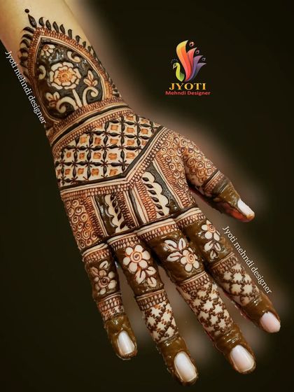 A lovely back-hand design that extends up the arm. It features a mix of floral patterns, traditional check-fills, and delicate work on the fingers.