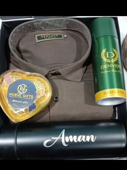 A simple yet elegant hamper with a Versace shirt, chocolates, deodorant, and a personalized flask.