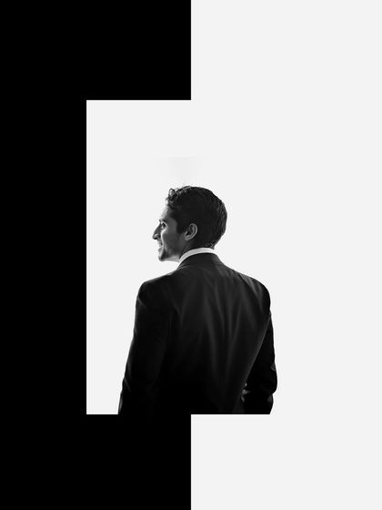 A creative black and white groom portrait with a bold graphic border. This artistic style is perfect for creating a standout image that feels like a magazine cover.