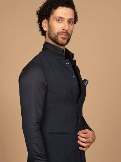 A side profile of the navy Western Jawahar jacket, showcasing its clean lines and modern silhouette. This is a versatile piece that can be dressed up or down for any formal occasion.