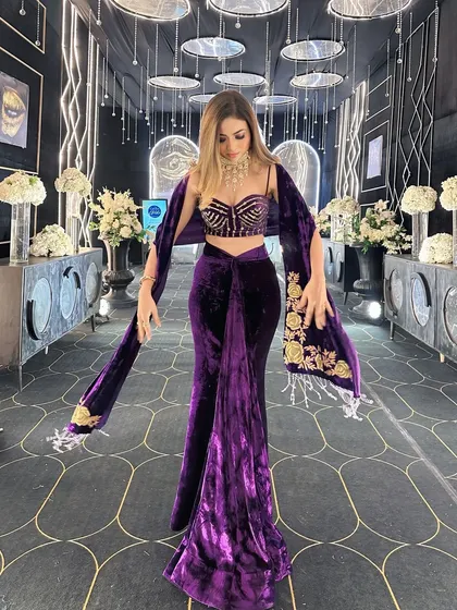 A full view of the stunning black and gold themed walkway I designed for a sangeet. The combination of a patterned floor, hanging mirrored discs, and linear lighting creates a dramatic and glamorous entrance.