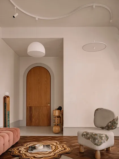 This image captures a collection of our unique seating and table designs. From a plush, channel-tufted sofa to a sculptural lounge chair made of upholstered stone, each piece is designed to be a work of art.