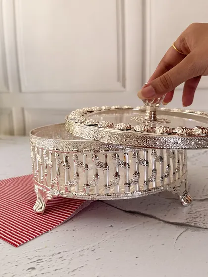 Lifting the lid reveals the spacious interior, perfect for holding a generous amount of treats. This piece beautifully marries form and function.