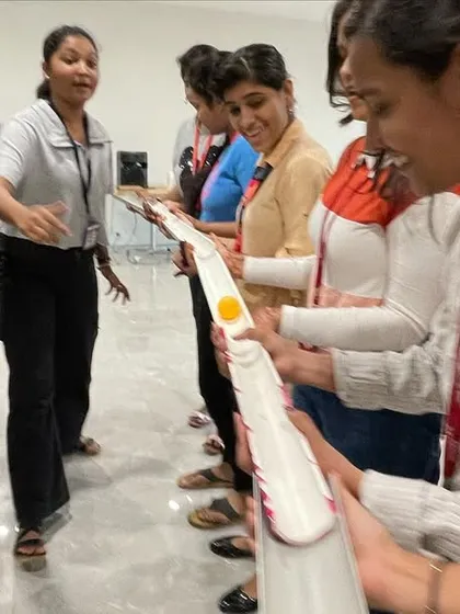 A close up of the action during a team coordination game. The focus and smiles on their faces show how engaging these activities can be for corporate teams.