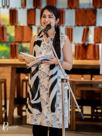 A poet shares her work at an open mic. Whether you have a published book or a poem in a notebook, our stage is open for you to share your voice.