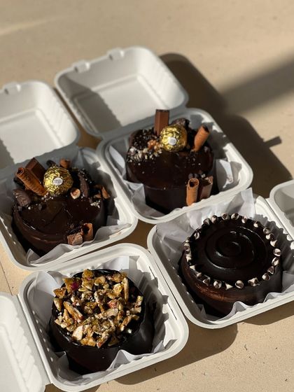 Another view of our assorted bento cakes, featuring Ferrero Rocher, nuts, and chocolate swirls.
