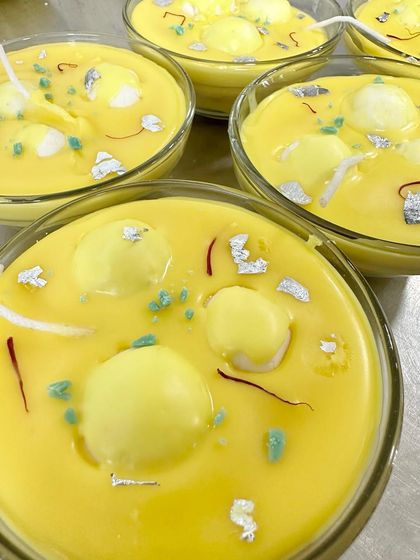 A batch of my rasmalai soy candles, freshly poured. These look absolutely divine, with wax 'rasgullas' floating in a yellow wax base, topped with saffron strands and silver vark.