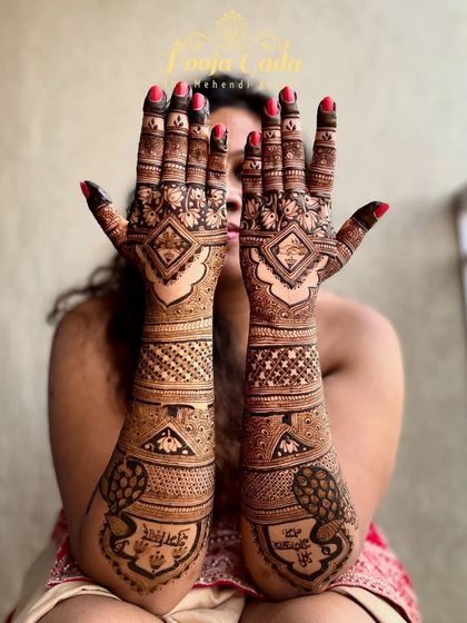 My NRI bride from Dubai showing off her beautiful back-hand design, which features her and her groom's names in a lovely script.