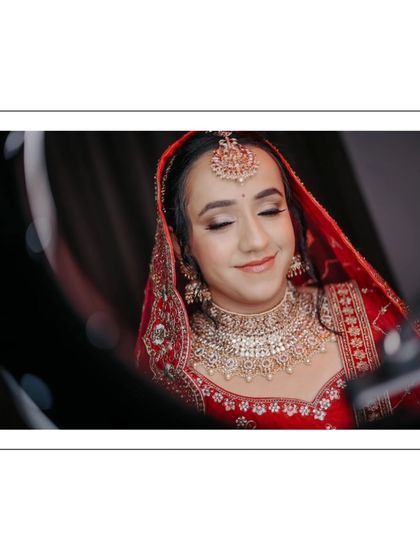 A close-up of Shreya, her eyes closed, as if making a wish, her makeup and jewelry captured in beautiful detail.