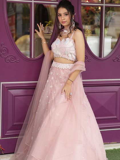 A perfect bridesmaid or engagement look featuring our light pink lehenga with star embellishments. It's a youthful and dreamy option for your portfolio.