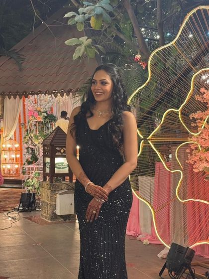 Another look at our popular black sequin gown, styled for a wedding reception. It’s a versatile piece that flatters every body type and guarantees you’ll be the best-dressed guest.