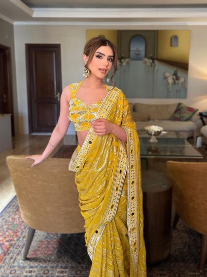 The full look, showing the stunning yellow saree and the modern, shimmery makeup that complements it perfectly.