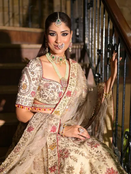 A confident and happy bride, looking directly at the camera. Her smile is the best accessory to this stunning ivory and floral ensemble.