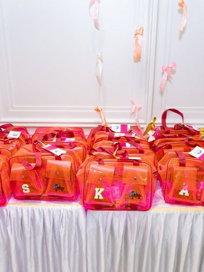 Personalized return gift bags, a thoughtful touch to thank guests for celebrating. These were for a chic, bow-themed party.