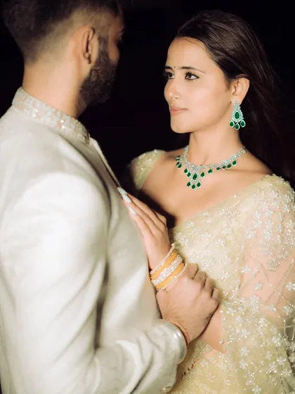A dramatic, high-fashion pose against a dark background. This shot from a rooftop engagement in Mumbai highlights the couple's stylish outfits and creates a modern, edgy, and cinematic feel.