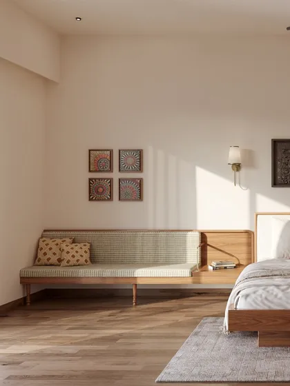 Every corner is an opportunity for design. An integrated bench seating by the window provides a cozy nook, complemented by framed traditional motifs on the wall that echo the room's modern Indian character.