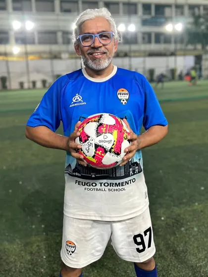 Nitin, a member of our working professionals batch, poses with a ball. He is proof that you can continue to play and improve at any age.