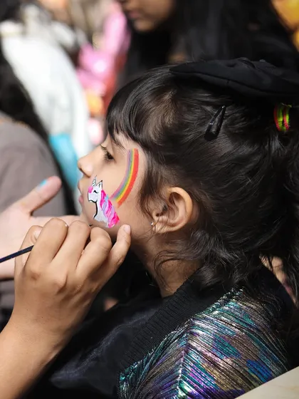 A magical moment as a child gets a unicorn and rainbow painted on her face. Our professional face painters are always a huge hit, transforming little ones into their favorite characters and adding a touch of whimsy to the day.