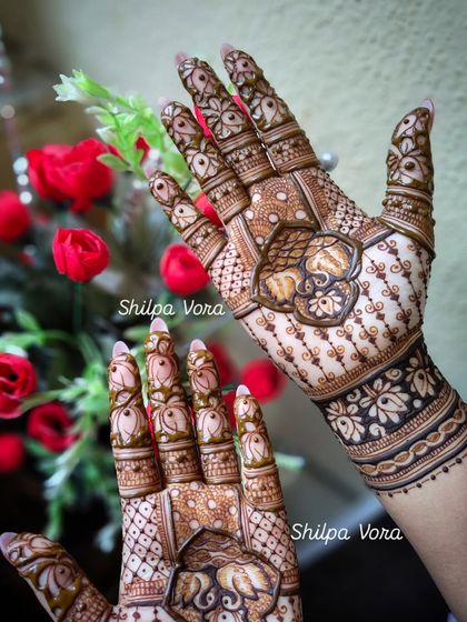 Another view of the elephant mandala design, shown against a background of red roses.