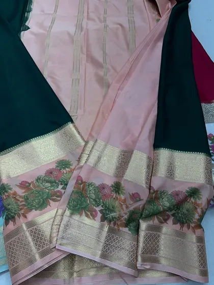 A beautiful color combination of bottle green and peach in my semi-Mysore crepe saree collection, featuring a floral Kalamkari border.