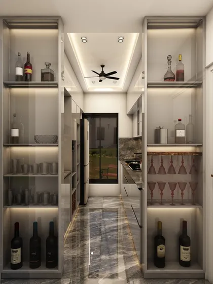 This design cleverly incorporates a bar and glassware storage unit at the entrance of the kitchen, creating a perfect transition to the dining or living area.