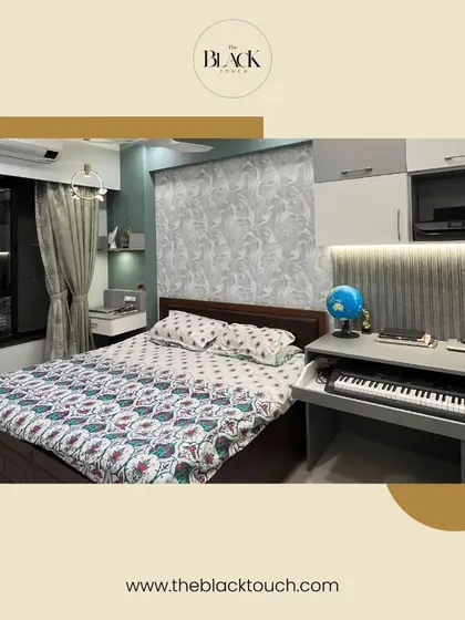 This bedroom combines functionality with style, featuring a built-in desk and keyboard next to the bed. The design is perfect for a multi-purpose room, offering a comfortable space for both rest and work.