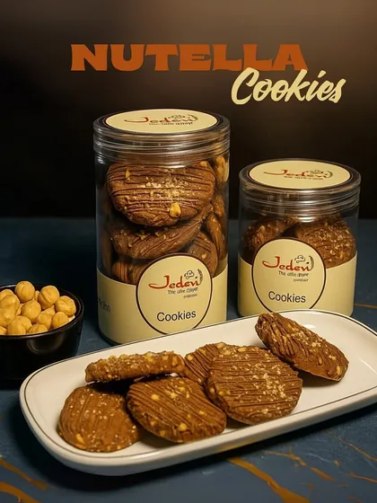 Behold our rich and nutty Nutella Cookies. This image captures the irresistible combination of crunchy hazelnuts and decadent chocolate, drizzled to perfection and available in our signature jars for you to enjoy anytime.