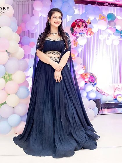 A full-length shot of the navy blue gown, showing its beautiful flare and modern design. Perfect for a birthday party or reception.