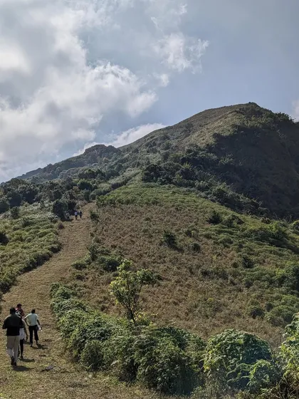 The upward climb on the Nishani Motte trail, surrounded by the green hills of the Brahmagiri range.