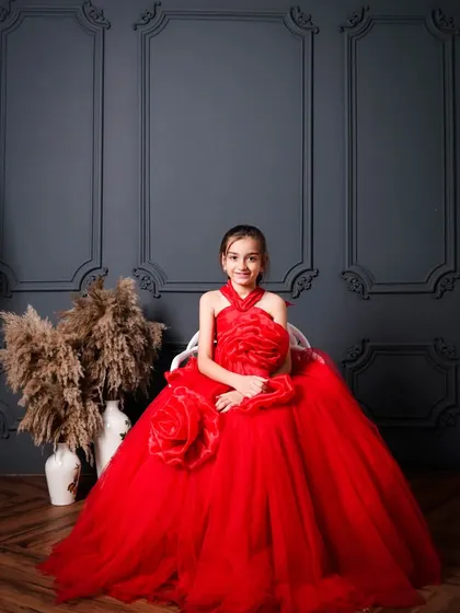 A full portrait of this little girl in the red floral gown. The classic wall molding in my studio adds a touch of elegance to any photoshoot.