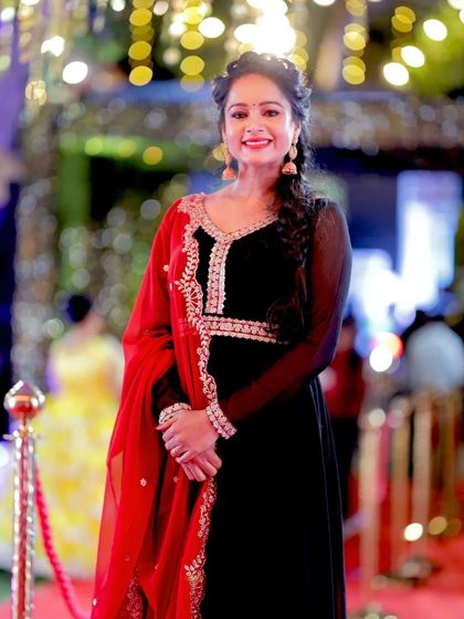 A full-length view of Duniya Rashmi's elegant Anarkali, showing the beautiful embroidery and the flow of the dress.