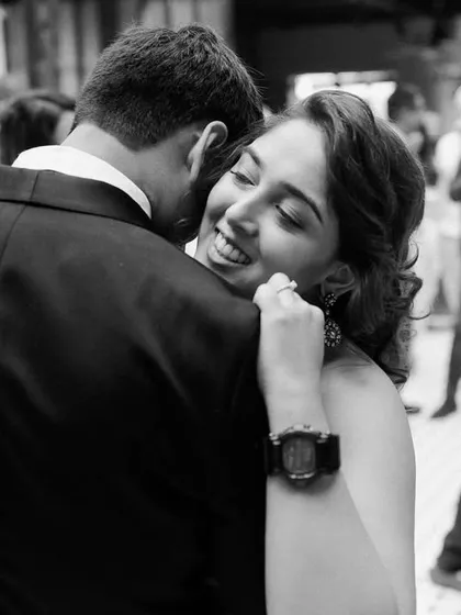 A candid moment of affection on the dance floor. The bride leans into her groom, a look of pure happiness on her face. These are the real, joyful moments that make a wedding celebration so special.
