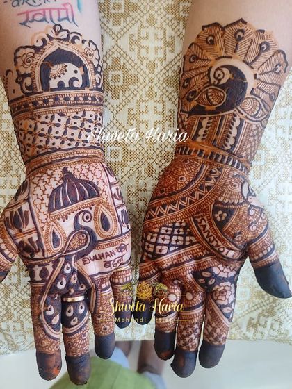 A unique bridesmaid design combining different motifs on each hand, one with a peacock and the other with an elephant, for a personalized touch.