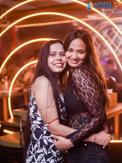 A hug between friends captures the warmth and fun of the night.