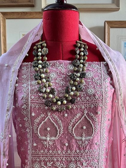A classic blush pink silk chanderi suit, heavily embellished with sequins and seed pearls for a touch of glamour. The ombré dyed dupatta adds a modern, sophisticated feel.