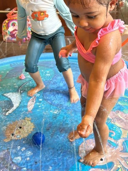 A toddler enjoying our splash mat. The gentle sprinklers are perfect for the little ones who are just getting comfortable with water play.