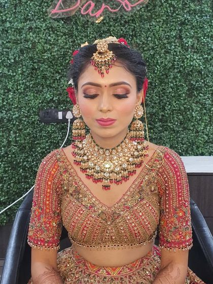A full view of the bridal makeup with eyes closed, showcasing the detailed eye work with blended shadows and false lashes that open up the eyes.