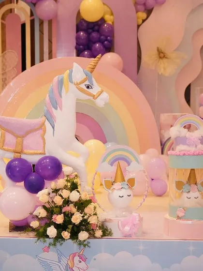 A detailed shot of the life-sized unicorn prop, complete with a saddle and surrounded by flowers and balloons.