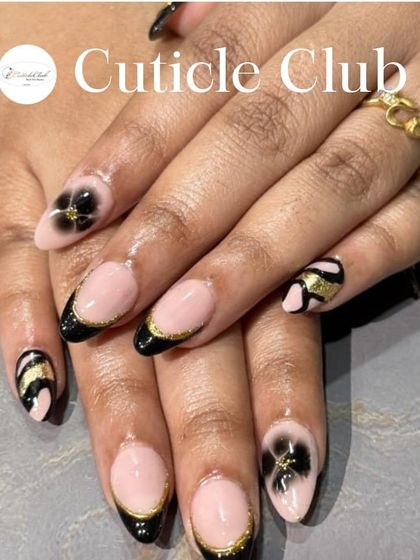 A chic and stylish design featuring a black French tip with a fine gold glitter line. The accent nails include a translucent 3D black flower and gold and black stripes.