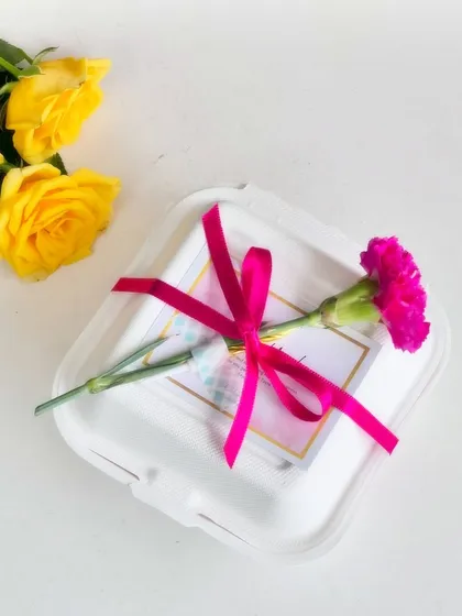 Every cake is a gift. I offer special packaging options, like this bento box tied with a vibrant pink ribbon and a fresh carnation, to make your sweet gesture even more memorable.