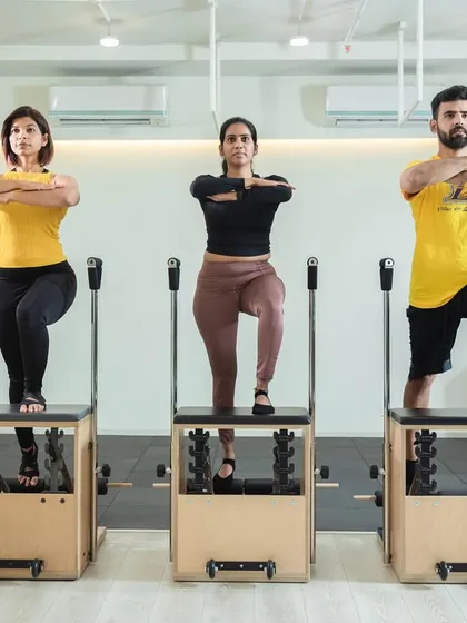 Our instructors demonstrating perfect synchronized form on the Pilates Chairs. We prioritize safety and confidence in every class.