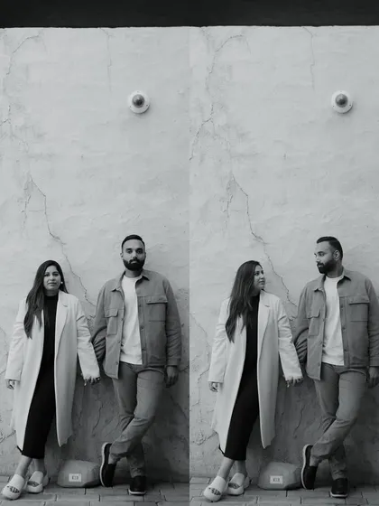 A modern, stylish black and white portrait of a couple in Dubai. The clean background and their confident poses create a very chic and contemporary image.