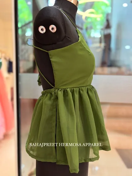 A side view of the olive green PEECHA kurti, showing the open back and delicate strap design.