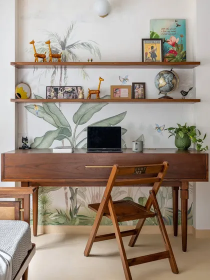 We believe furniture must be as functional as it is beautiful. For the Layam residence, we designed this custom study table that cleverly conceals a piano, providing an elegant workspace while maximizing storage and efficiency in the room.