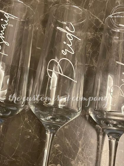 Cheers to the bride and her bridesmaids. These elegant champagne glasses are individually personalized, making them a perfect keepsake for your bachelorette party or getting-ready toast.