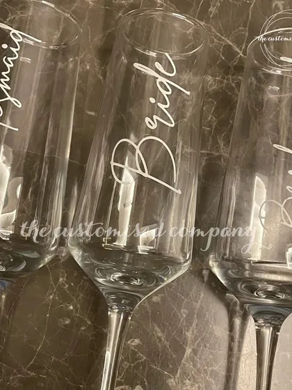 Cheers to the bride and her bridesmaids. These elegant champagne glasses are individually personalized, making them a perfect keepsake for your bachelorette party or getting-ready toast.