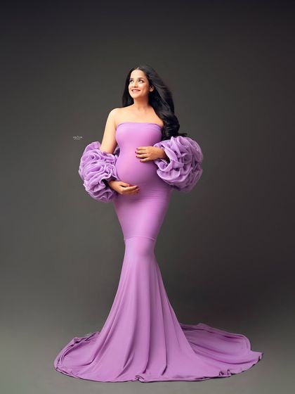 This beautiful mamma is absolutely radiant in our lavender Rosa gown. The color is so soft and dreamy, and the ruffled sleeves add that perfect touch of drama.