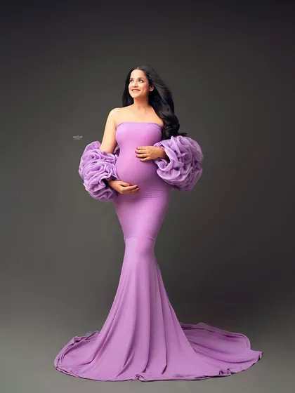 This beautiful mamma is absolutely radiant in our lavender Rosa gown. The color is so soft and dreamy, and the ruffled sleeves add that perfect touch of drama.