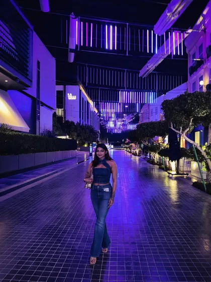 Styling is about creating a vibe that fits the environment. This denim-on-denim look, featuring a halter top and flared jeans, was perfect for a night out exploring the vibrant, neon-lit streets of Dubai.