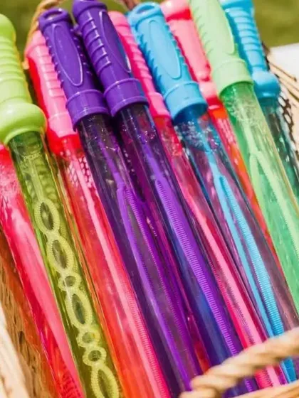 Fun and playful details for a Sagan party. A basket of colorful bubble wands was provided for guests to add a touch of whimsy and fun to the celebration.